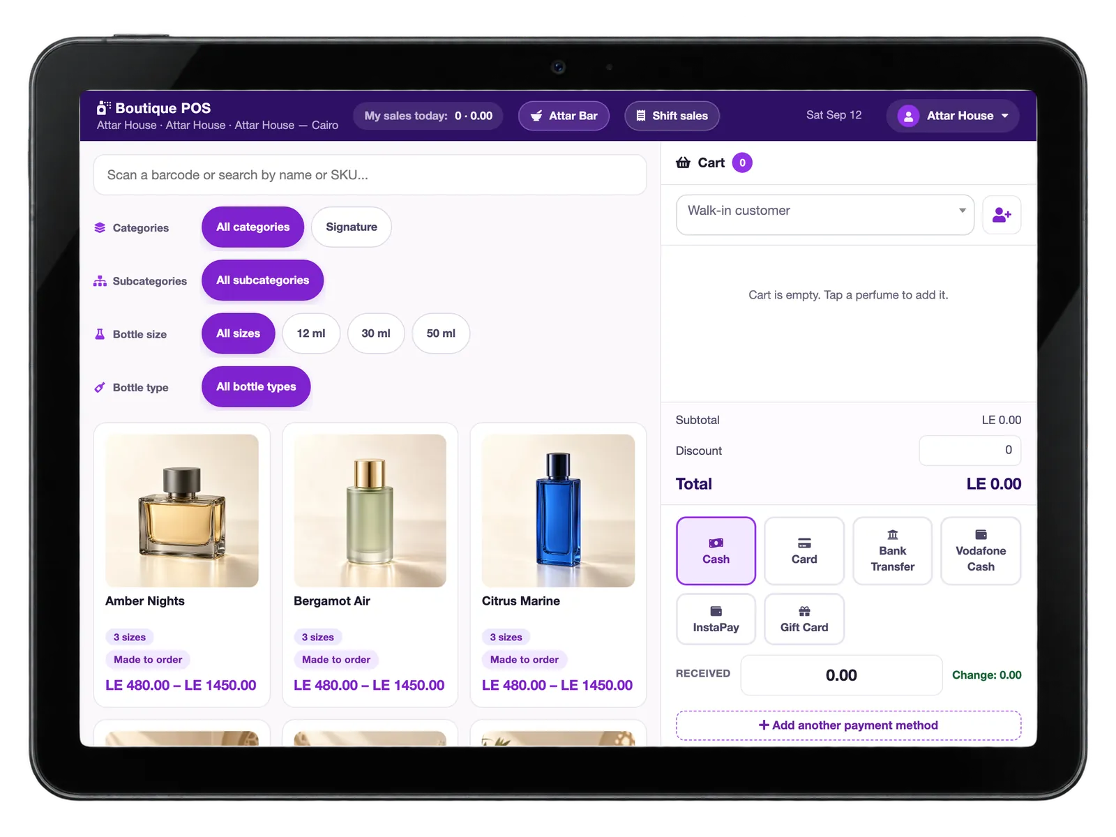 A countertop terminal showing the boutique point of sale: perfume bottles with size filters and a made-to-order badge.